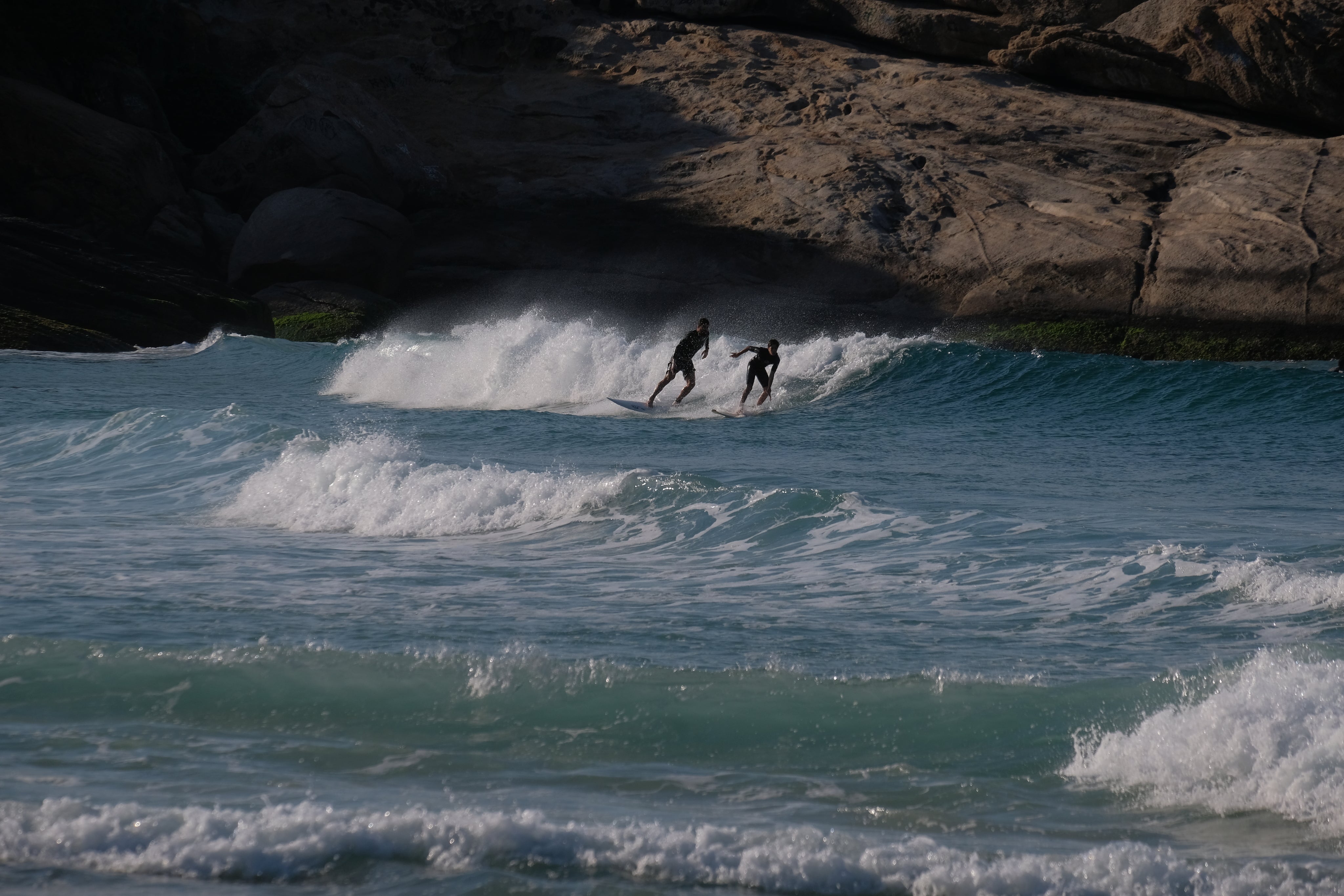 two-people-surfing-in-blue-choppy-water.jpg